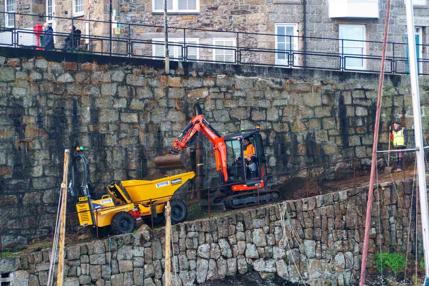 Loading the dumper with topsoil and growth